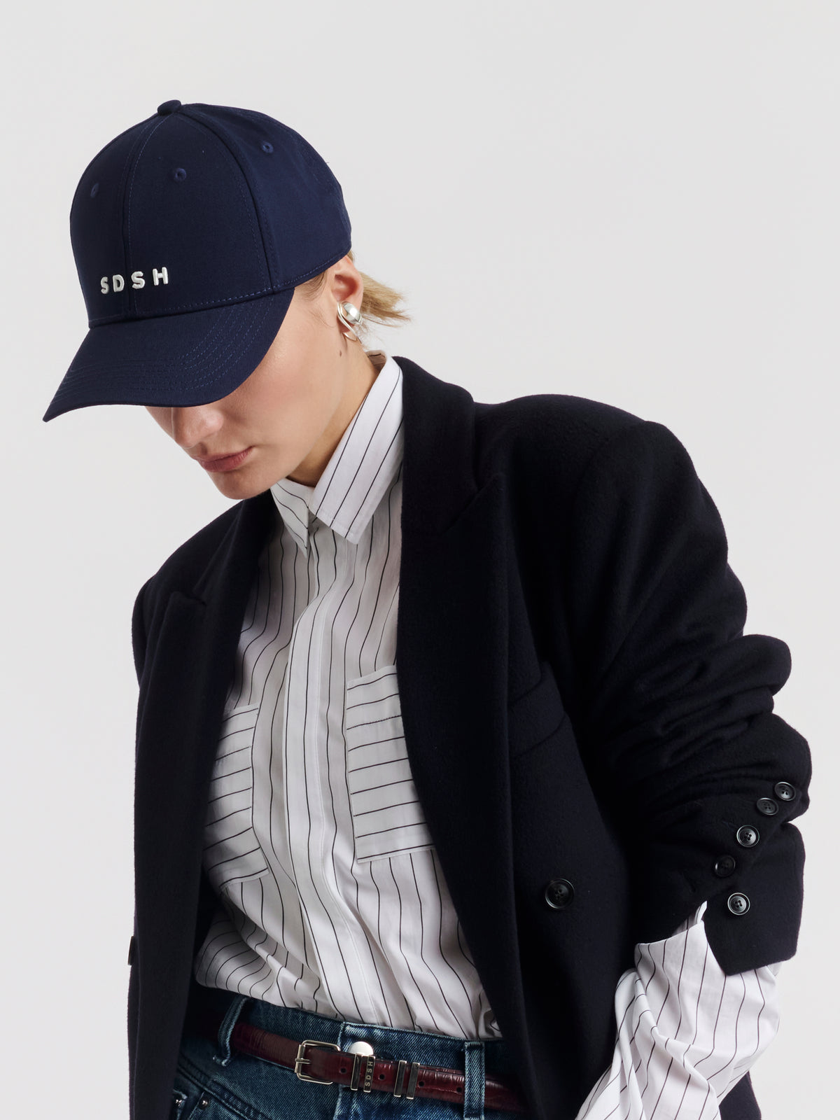 Navy GAELLE cap worn, with embroidered SDSH monogram