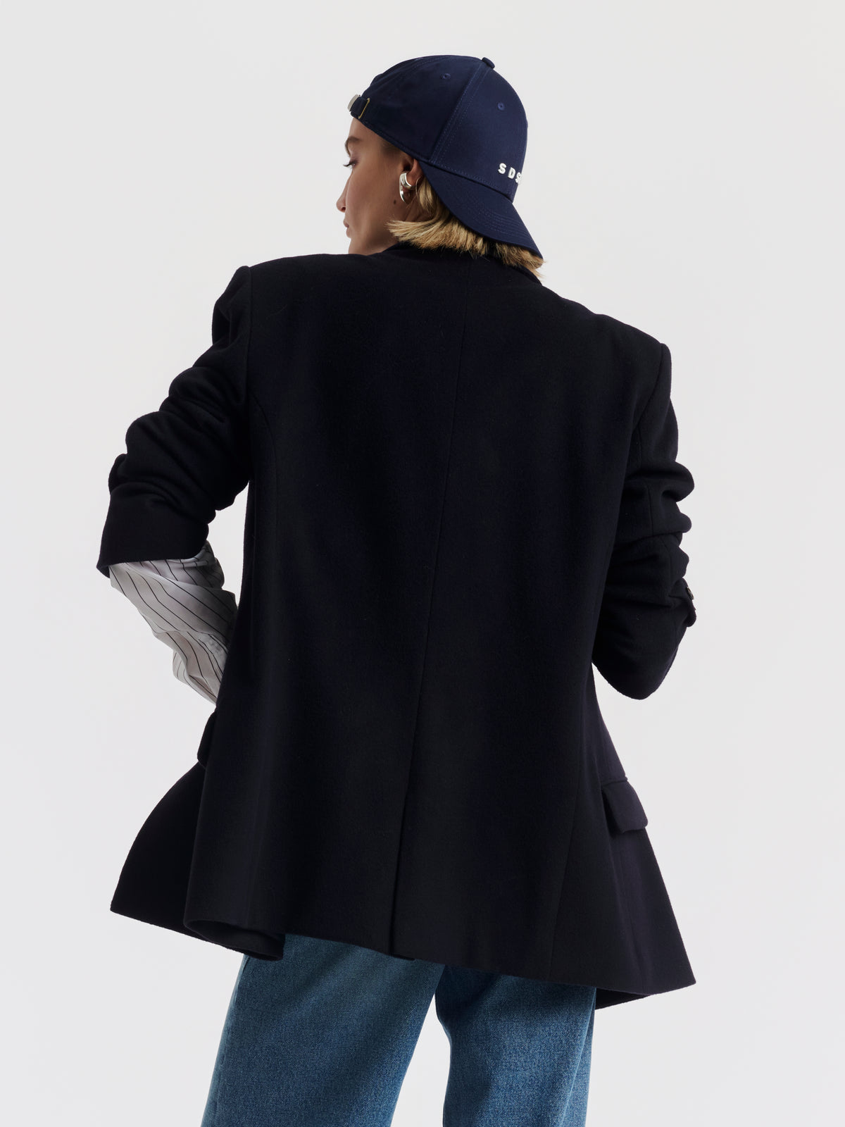 Navy GAELLE cap worn, with embroidered SDSH monogram