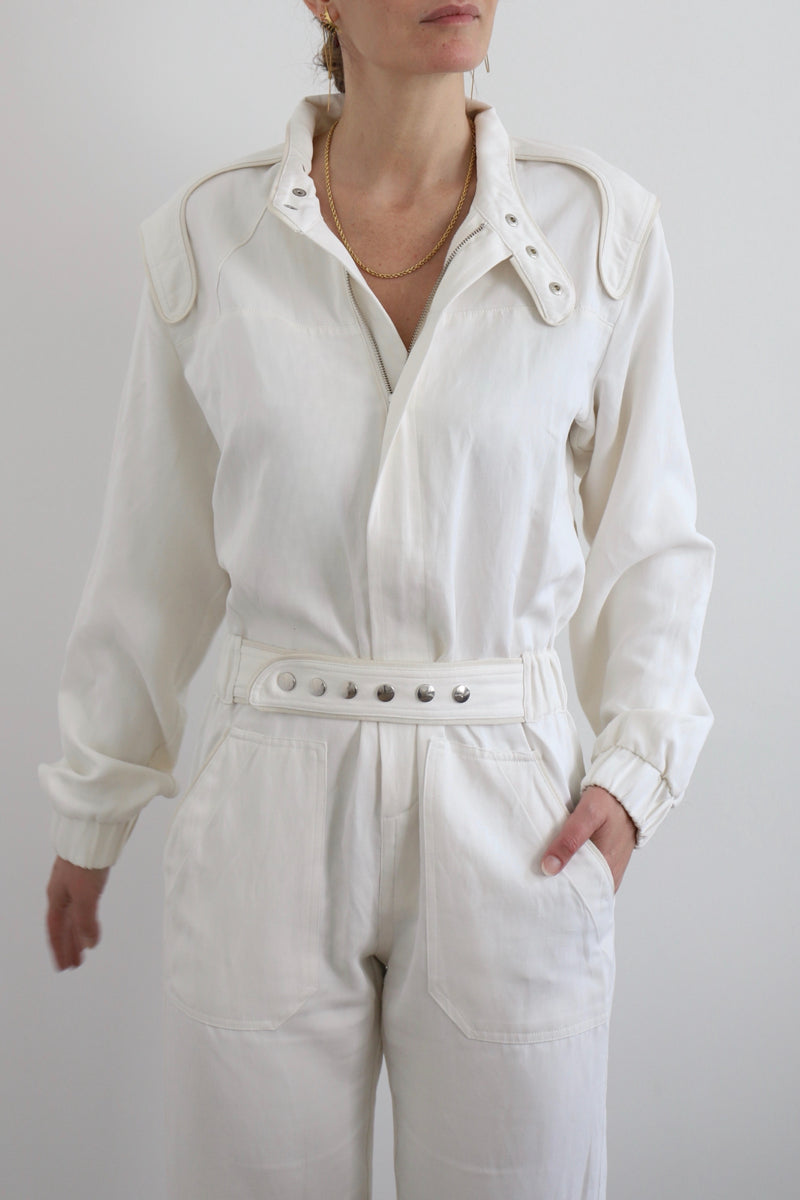 SARAH DE SAINT HUBERT Heritage racing jumpsuit with SDSH signature details. Beautiful silk-hemp fabric sourced from a Luxury House deadstock. Beige gros-grain finishings. Iconic rows of metal snaps at the collar and waist. Boyish and feminine look. Straight and relaxed fit. Made in Portugal