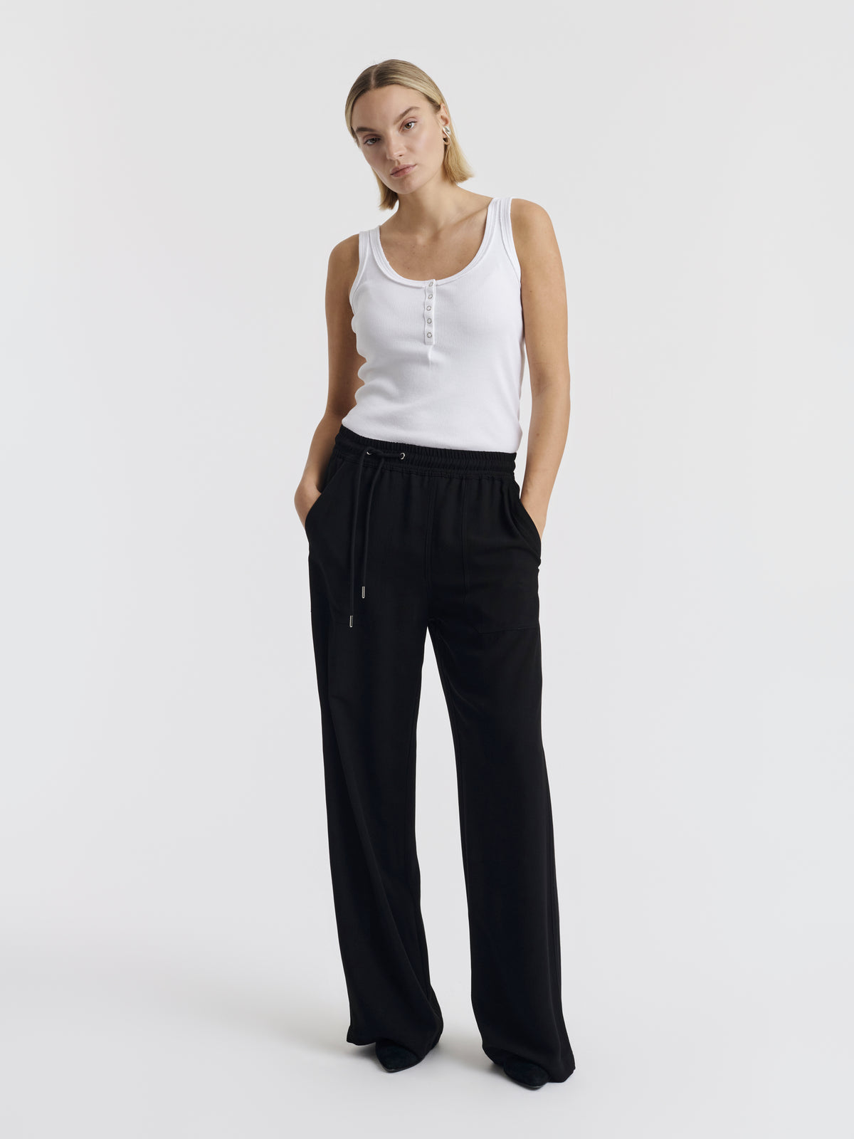 Black VIC CREPE wool wide-leg trousers worn with the white ANNET tank top