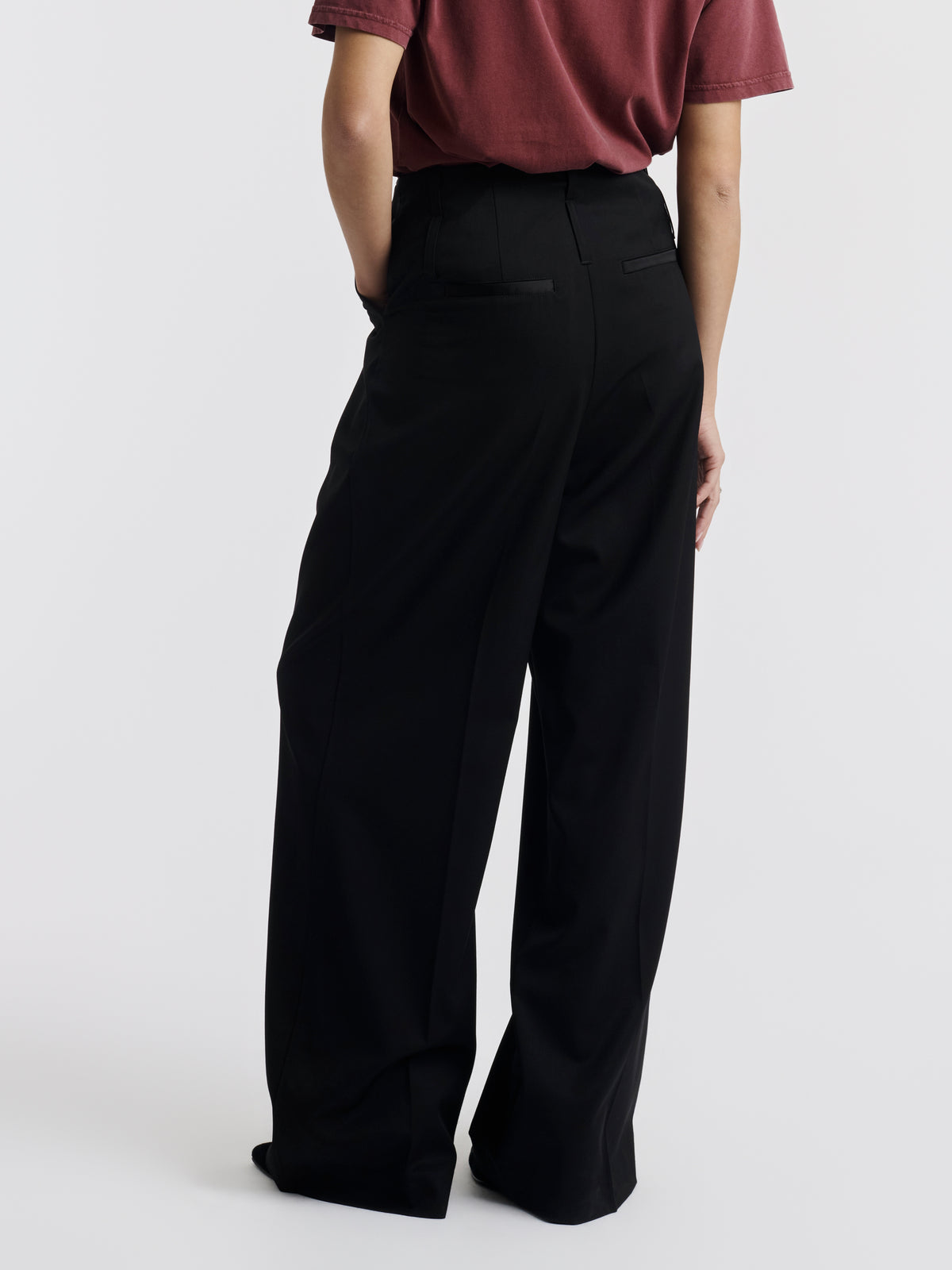 Black WOODY wide-leg trousers worn, back view