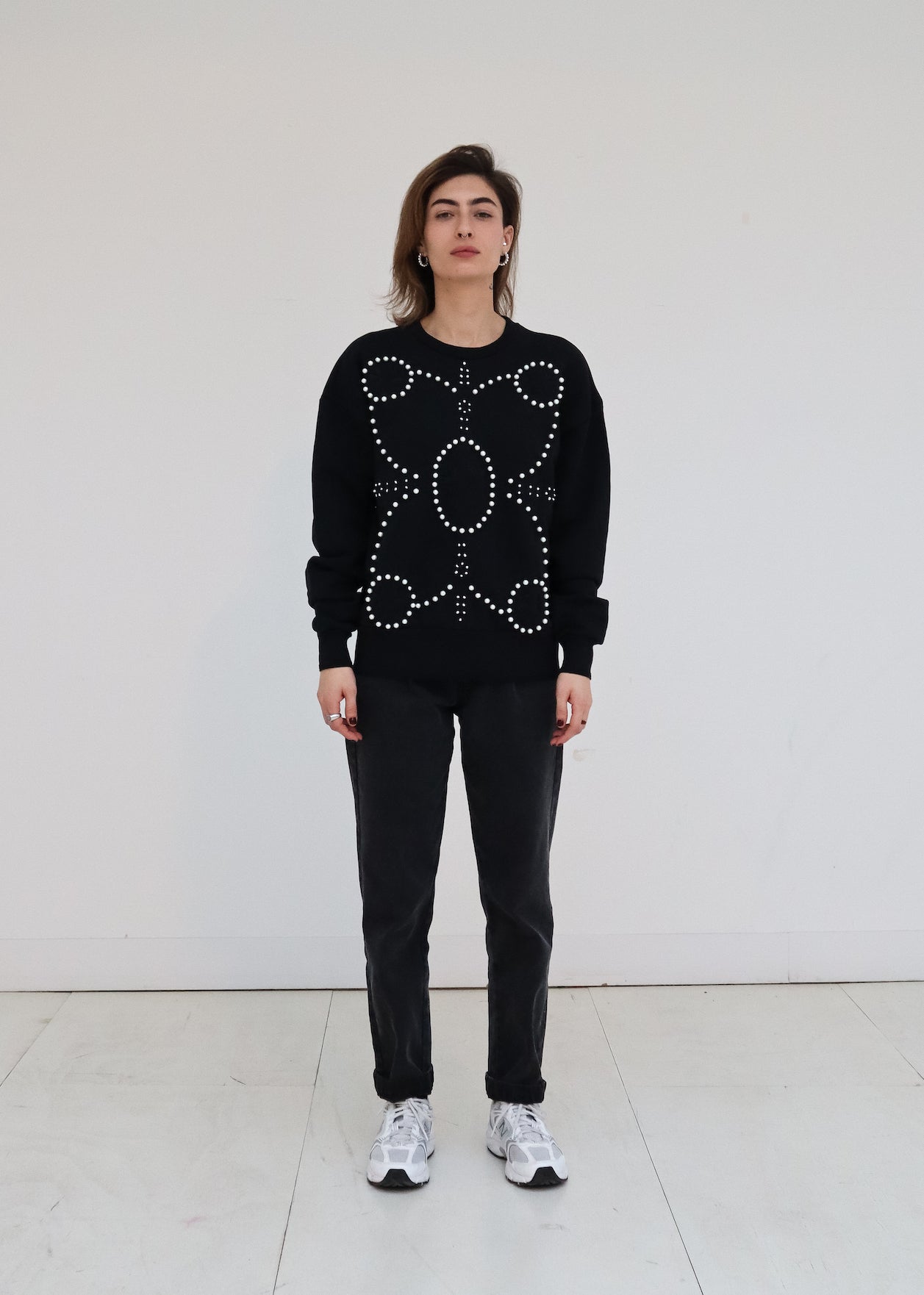 Signature Sweatshirt featuring our iconic 'broderie anglaise' at the front. Hand-embroidered in BELGIUM with large Pearls (Perles de Mallorque). Hand-embroidered in BELGIUM with small pearls (Perles de culture, type 'grains de riz') relaxed fit, dropped shoulders. 100% black cotton Kara is 168 cm tall and wears a size XS Made in Portugal, embroidered in Belgium other sizes available on demand