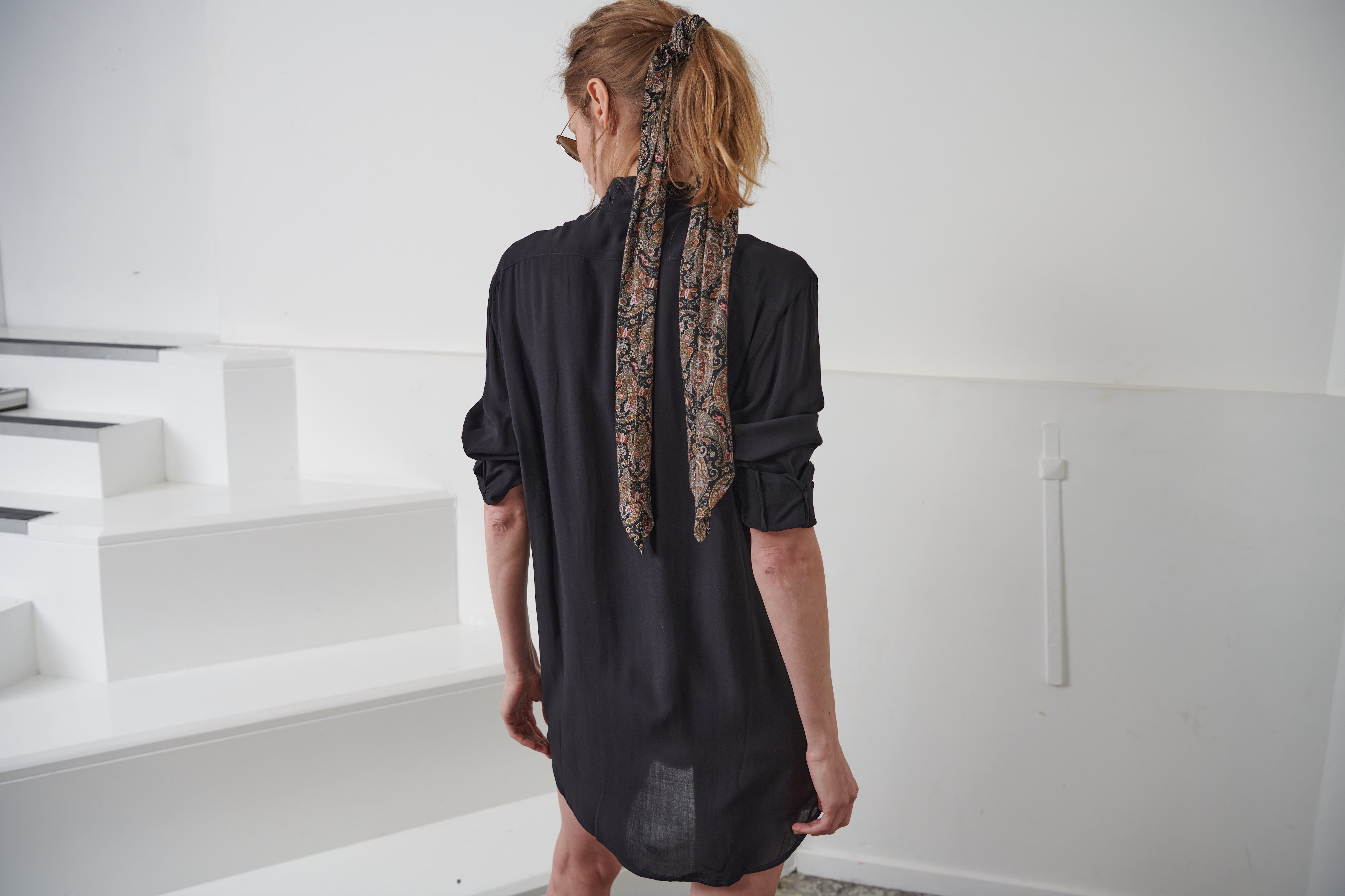 Fluid black shirt dress for women with English embroidery application, loose fit. Smoldering cuffs with self-covered black viscose buttons with black cotton eyelet embroidery. 100% Viscose. Made in portugal
