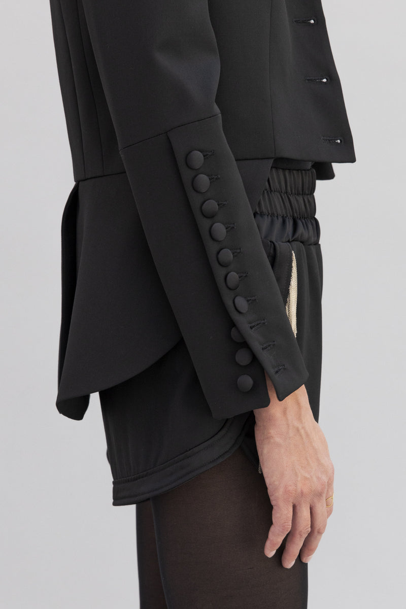 SARAH DE SAINT HUBERT satin black jacket made of virgin wool with hand embroidered chains. Feminine rock’n’roll silhouette.