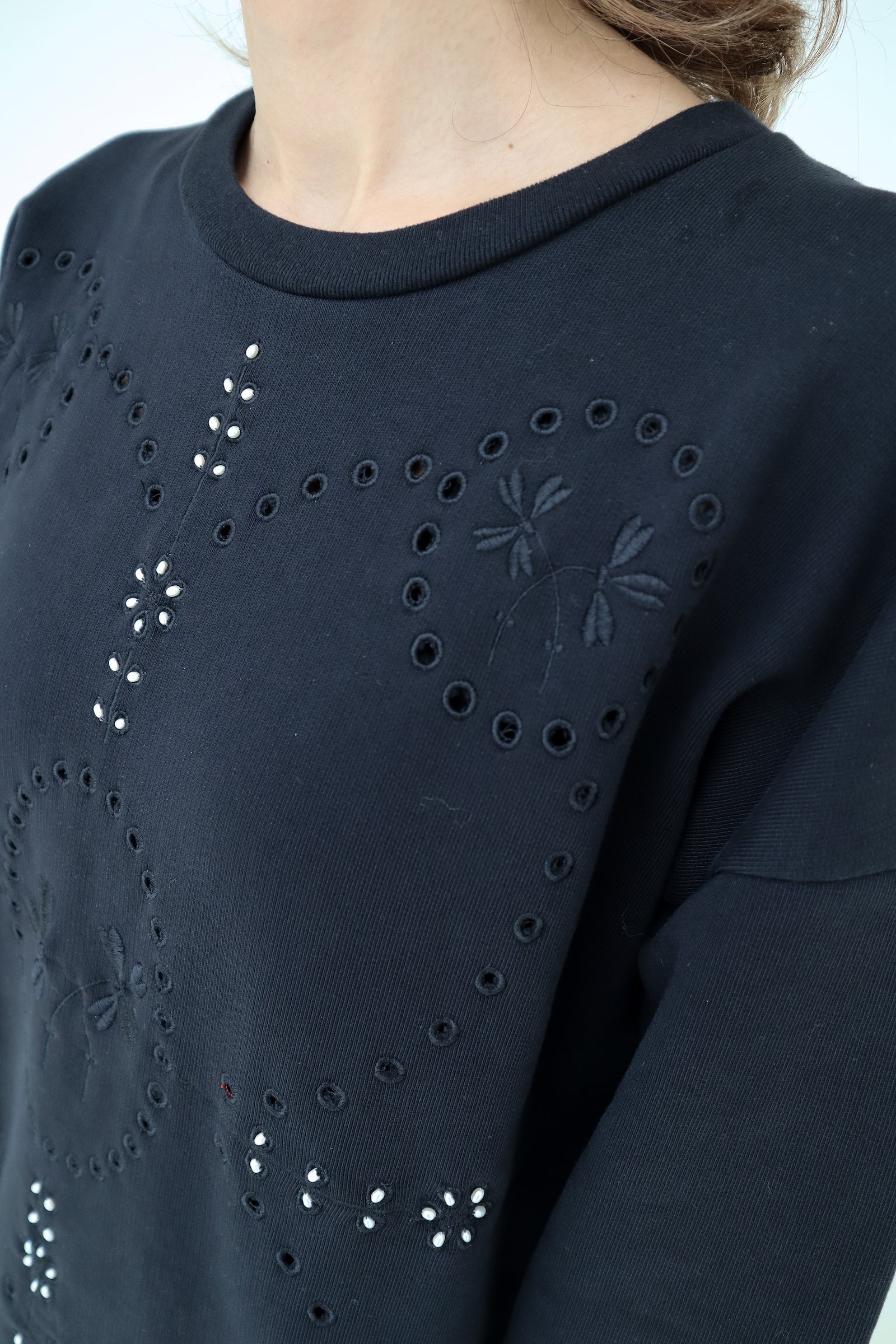 Signature Sweatshirt featuring our iconic 'broderie anglaise' at the front. Hand-Embroidered in BELGIUM with small pearls at the front (perles de cultures, 'grains de riz'). Relaxed fit, dropped shoulders. 100% black cotton. Made in Portugal, embroidered in Belgium other sizes available on demand