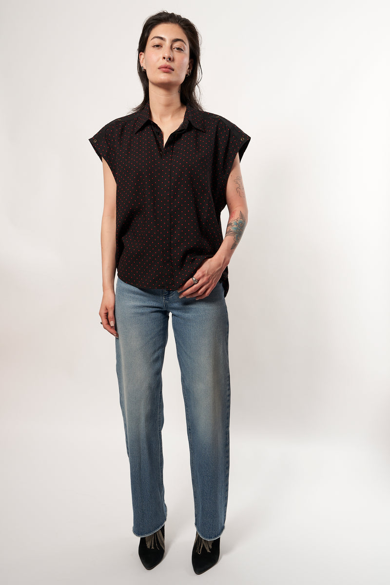 SARAH DE SAINT HUBERT fluid shirt made of viscose. A timeless feminine shirt with a relaxed fit. Fluid black printed dots shirt with 'straight shoulder pads' look. Shoulders can be worn either loose or folded inside to get the look. Black gros-grain tape with press buttons at the shoulders. Blind placket at the front side. Loose & straight fit, true to size 100% black viscose with red dots printed Made in Portugal.
