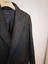 Crafted from 100% pure wool, this coat is a tribute to understated luxury. Its flowing silhouette whispers sophistication, enveloping you in warmth without compromise. Whether layered over tailored ensembles or paired with casual staples, it becomes an effortless extension of your style. A timeless piece designed for those who seek beauty in simplicity and grace in every step. Produced in Portugal in limited quantities.