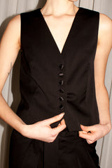 SARAH DE SAINT HUBERT Carmen women's black fitted waistcoat with satin self covered buttons. Made in black virgin wool. Elegant and feminine. Designed in Belgium. Made in Portugal.