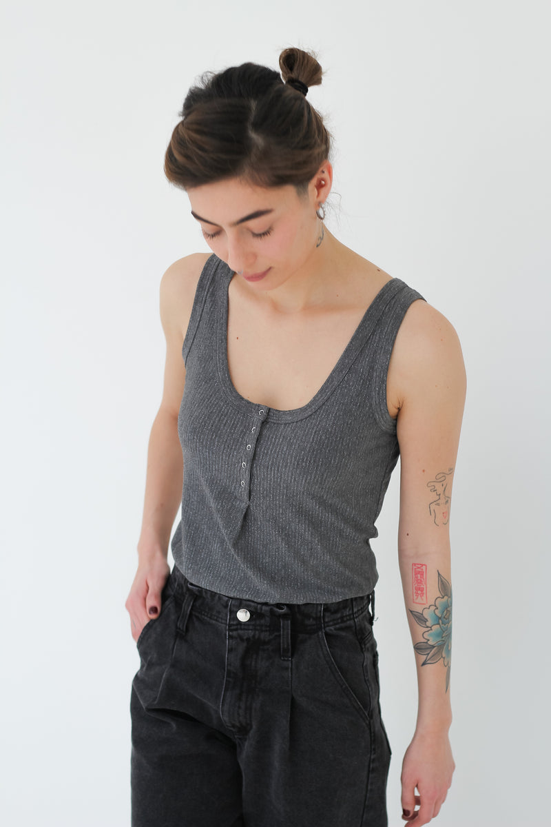 Deluxe jersey tank top with thin lamé stripes. Straight & slim fit press buttons placket at frontside. 100% grey viscose jersey with silver vertical lamé stripes Made in Portugal
