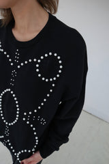 Signature Sweatshirt featuring our iconic 'broderie anglaise' at the front. Hand-embroidered in BELGIUM with large Pearls (Perles de Mallorque). Hand-embroidered in BELGIUM with small pearls (Perles de culture, type 'grains de riz') relaxed fit, dropped shoulders. 100% black cotton Kara is 168 cm tall and wears a size XS Made in Portugal, embroidered in Belgium other sizes available on demand