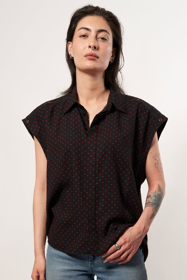 SARAH DE SAINT HUBERT fluid shirt made of viscose. A timeless feminine shirt with a relaxed fit. Fluid black printed dots shirt with 'straight shoulder pads' look. Shoulders can be worn either loose or folded inside to get the look. Black gros-grain tape with press buttons at the shoulders. Blind placket at the front side. Loose & straight fit, true to size 100% black viscose with red dots printed Made in Portugal.