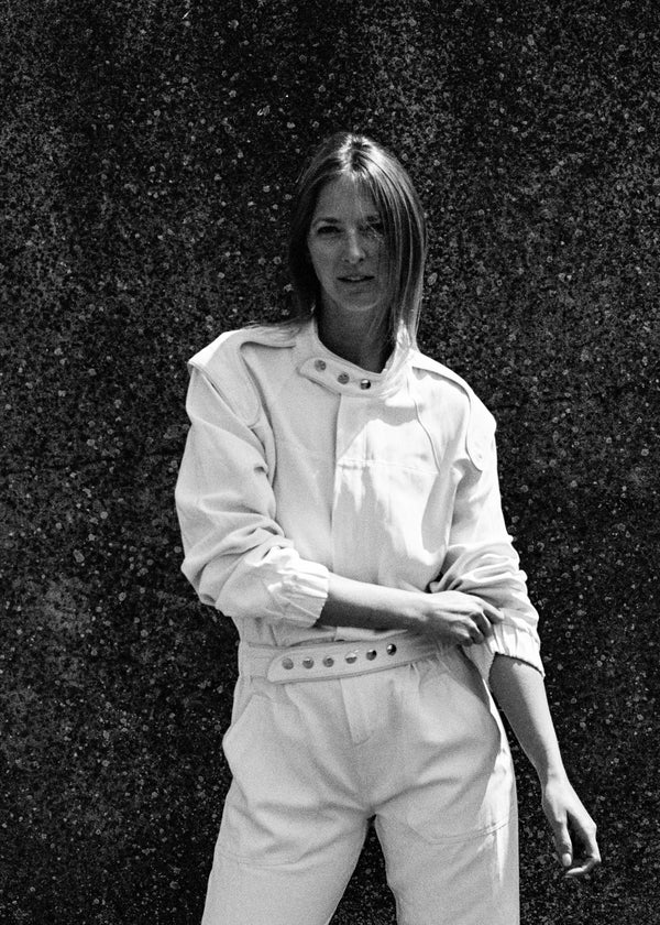SARAH DE SAINT HUBERT Heritage racing jumpsuit with SDSH signature details. Beautiful silk-hemp fabric sourced from a Luxury House deadstock. Beige gros-grain finishings. Iconic rows of metal snaps at the collar and waist. Boyish and feminine look. Straight and relaxed fit. Made in Portugal
