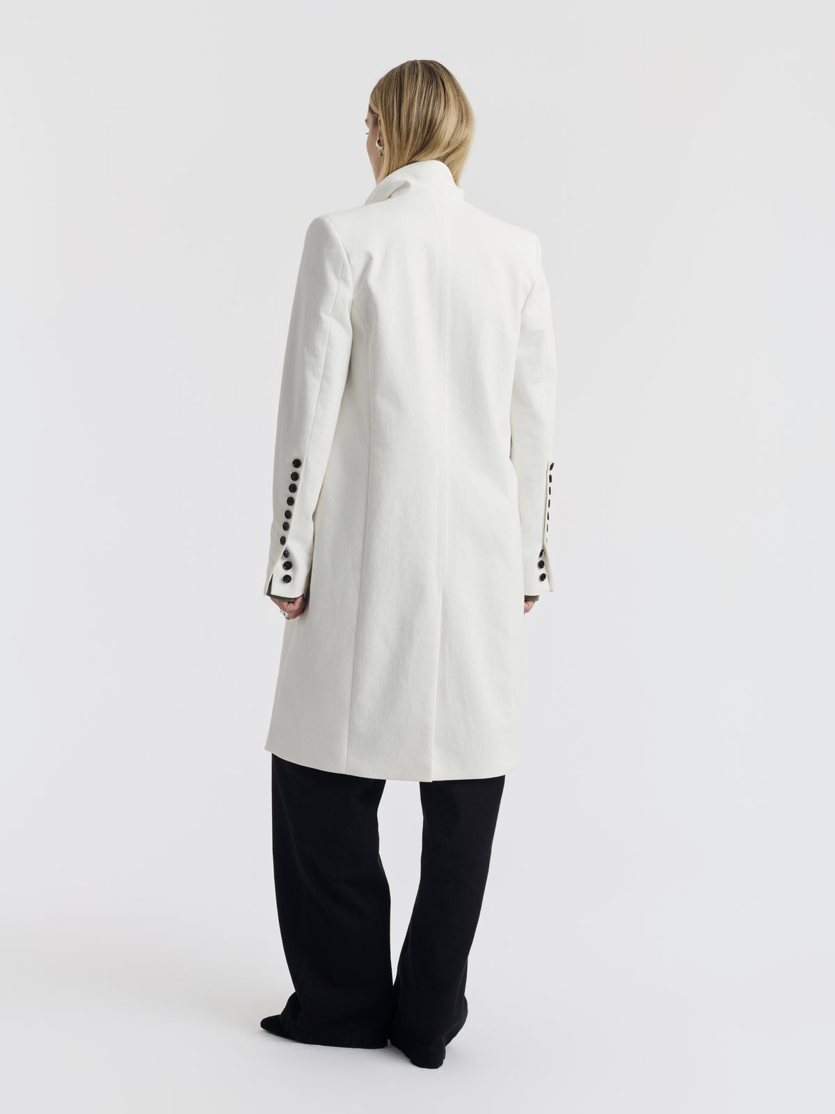 White cotton CARA coat with a row of black buttons on the cuff