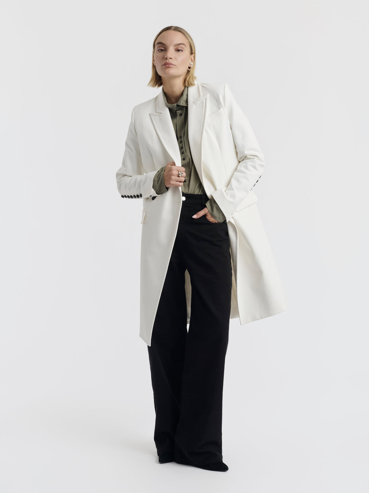 White cotton CARA coat with a row of black buttons on the cuff