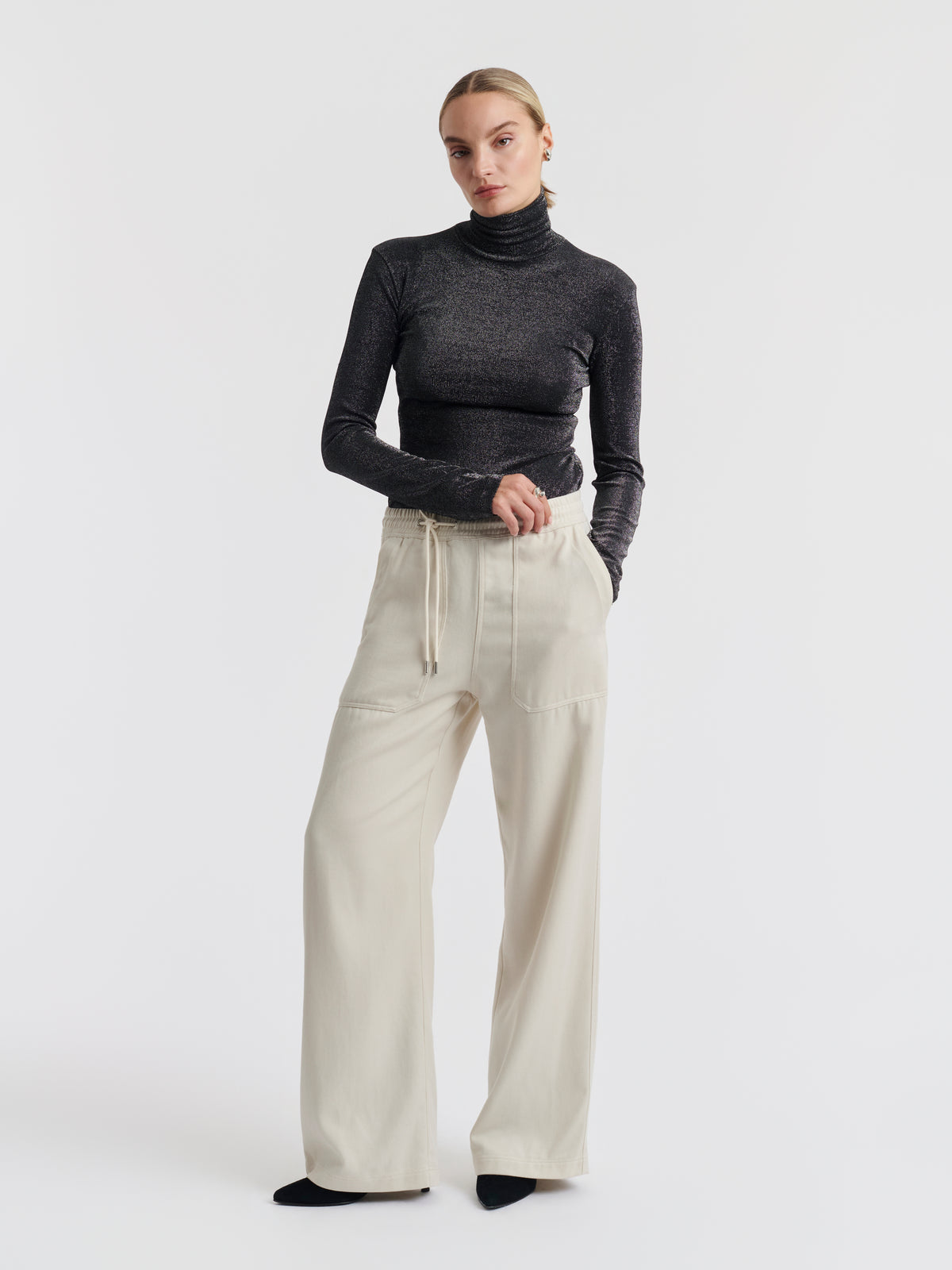 Black and silver ELISABETH lurex roll neck top worn, front view
