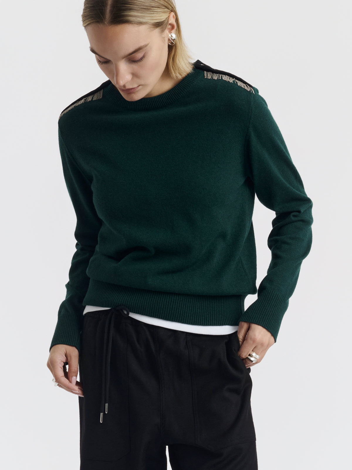 Hand-embroidered chains on the dark green ISA CHAINS jumper