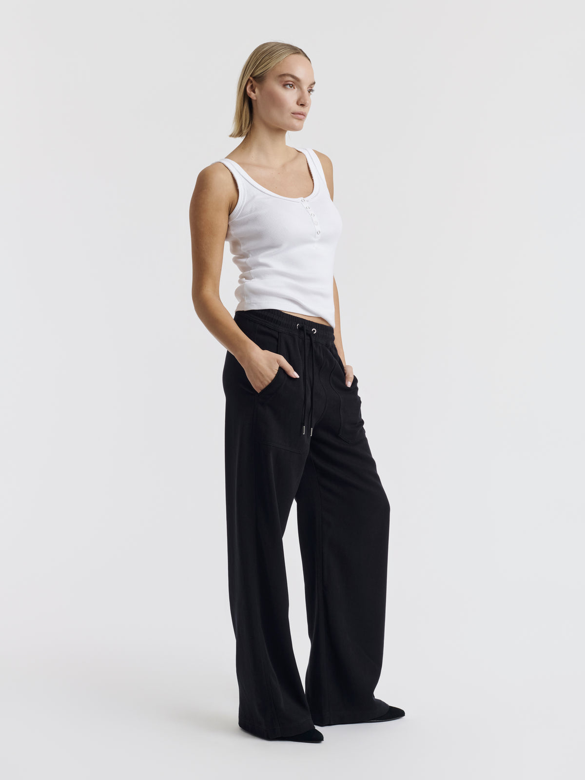 Dark navy VIC LYOCELL wide-leg trousers worn with the white ANNET tank top