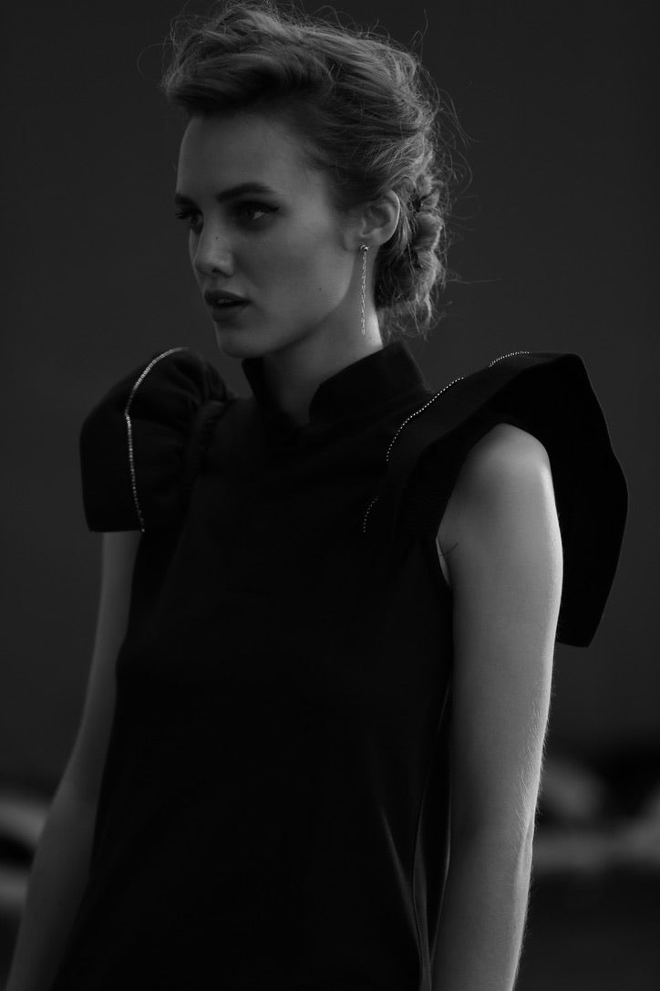 SARAH DE SAINT HUBERT black piqué polo shirt dress made of cotton with iconic ribbed butterfly sleeves. Feminine silhouette.