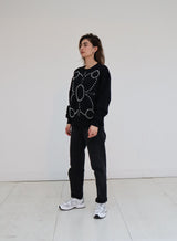 Signature Sweatshirt featuring our iconic 'broderie anglaise' at the front. Hand-embroidered in BELGIUM with large Pearls (Perles de Mallorque). Hand-embroidered in BELGIUM with small pearls (Perles de culture, type 'grains de riz') relaxed fit, dropped shoulders. 100% black cotton Kara is 168 cm tall and wears a size XS Made in Portugal, embroidered in Belgium other sizes available on demand