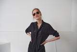 Fluid black shirt dress for women with English embroidery application, loose fit. Smoldering cuffs with self-covered black viscose buttons with black cotton eyelet embroidery. 100% Viscose. Made in portugal