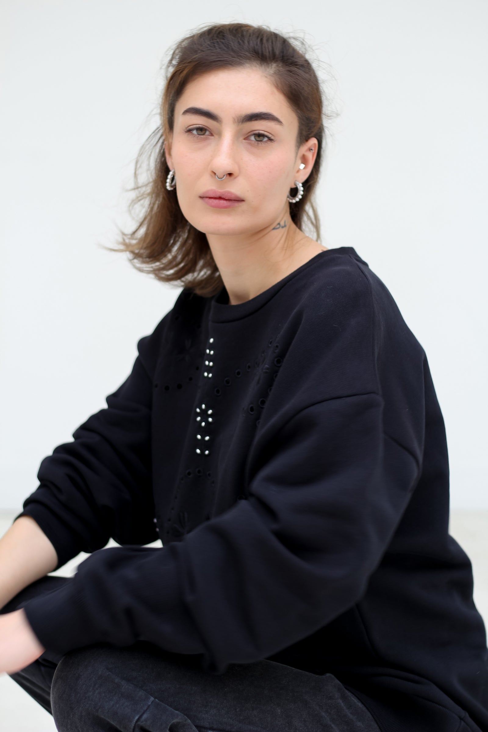 Signature Sweatshirt featuring our iconic 'broderie anglaise' at the front. Hand-Embroidered in BELGIUM with small pearls at the front (perles de cultures, 'grains de riz'). Relaxed fit, dropped shoulders. 100% black cotton. Made in Portugal, embroidered in Belgium other sizes available on demand